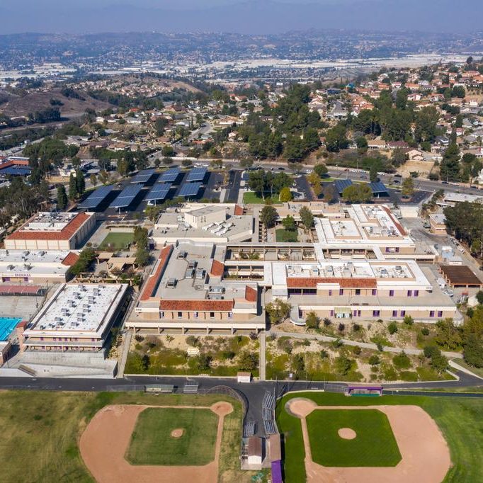 Aerial view of a school campus with multiple buildings and baseball fields.