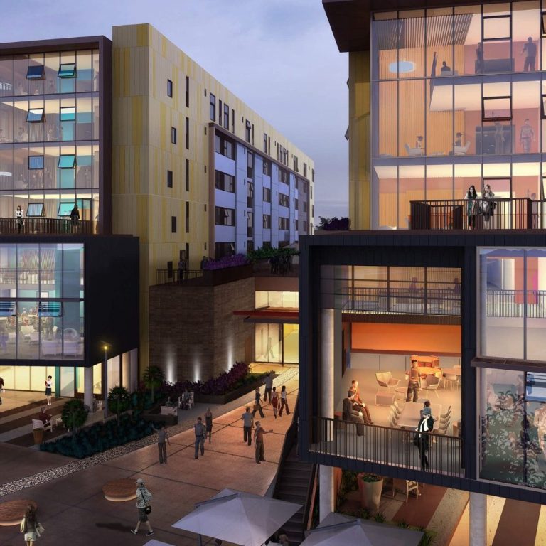 Modern apartment complex with outdoor seating and a lively courtyard at dusk.